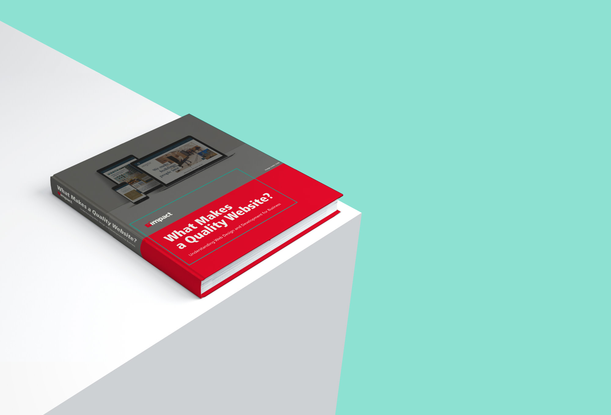 what makes a quality website book on the right corner of a table with teal background