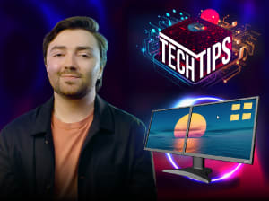 man smiling in front of red and blue background | how to set up dual monitors tech tips