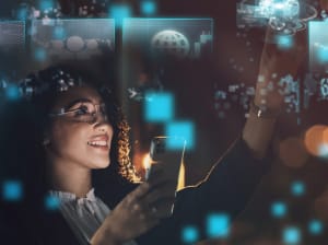 A woman holding a phone and working on a digital smart display