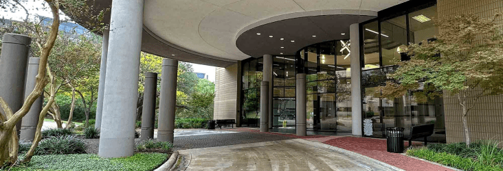 Driveway leading up to the building entrance with curved design overhead.